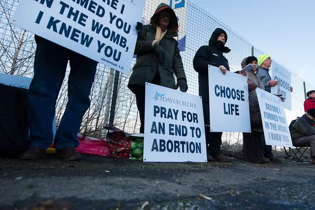 Members of the 40 Days For Life group hold a vigil as women head for appointments.