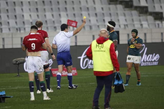 Match referee Ben O'Keeffe shows the yellow card South Africa's wing Cheslin Kolbe.