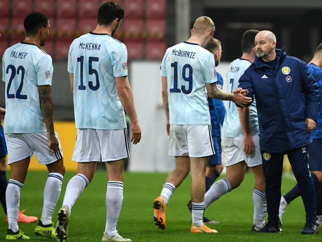 Scotland manager Steve Clarke (right) and Oli McBurnie shake hands after the final whistle.