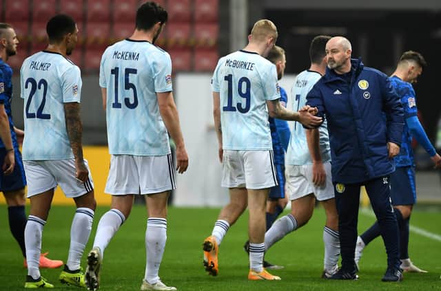 Scotland manager Steve Clarke (right) and Oli McBurnie shake hands after the final whistle.