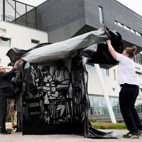 Martha Ellis and Professor Richard Butt unveiling the artwork on campus