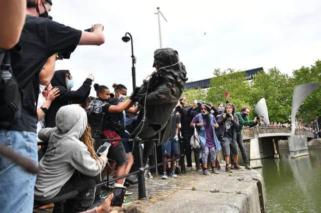Protesters throw a statue of slave trader Edward Colston into Bristol harbour during a Black Lives Matter protest in memory of George Floyd, who was killed in police custody in the US city of Minneapolis. (Picture: Ben Birchall/PA Wire)