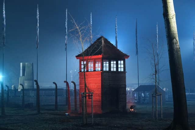 A guard tower stands illuminated at the former Auschwitz-Birkenau concentration camp near the Auschwitz Memorial. (Pic: Getty Images)