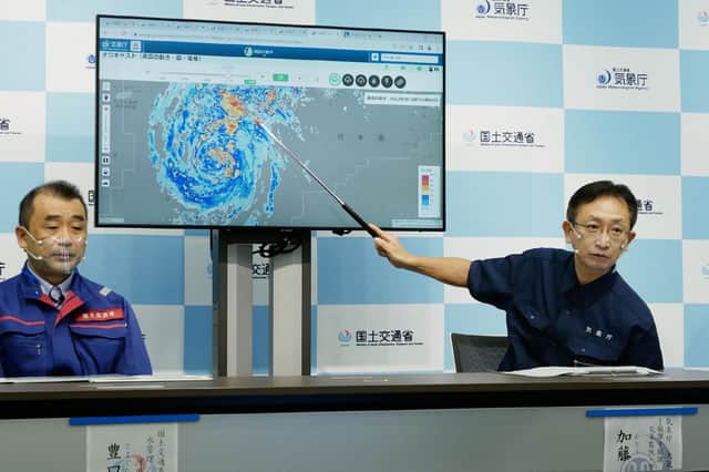 A director of the Japan Meteorological Agency's Forecast Division holds a press conference on Typhoon Nanmadol in Tokyo. (Photo by STR/JIJI PRESS/AFP via Getty Images)