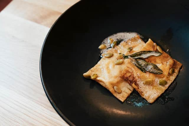 Starter of pumpkin and blue murder cheese ravioli with browned butter, crispy sage and toasted pumpkin seeds