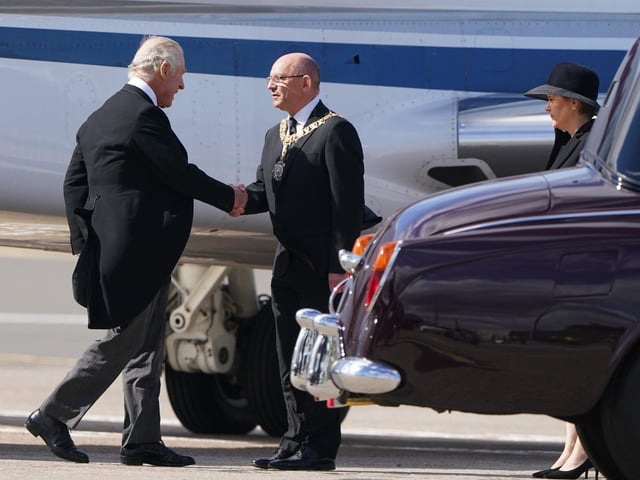 The First Minister of Scotland Nicolas Sturgeon waits to greet King Charles III as he arrives at Edinburgh Airport after travelling from London with the Queen Consort, ahead of joining the procession of Queen Elizabeth's coffin from the Palace of Holyroodhouse to St Giles' Cathedral, Edinburgh. Picture date: Monday September 12, 2022.