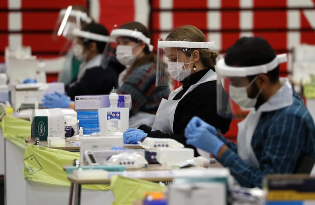 People carry out asymptomatic testing using lateral flow antigen at a test centre at Edinburgh University ahead of students being allowed to travel home for the Christmas holidays.