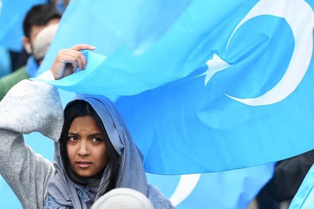 A woman takes part in a protest march in Brussels over the 're-education' camps for ethnic Uyghurs in China (Picture: Emmanuel Dunand/AFP via Getty Images)