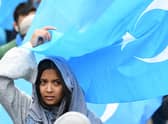 A woman takes part in a protest march in Brussels over the 're-education' camps for ethnic Uyghurs in China (Picture: Emmanuel Dunand/AFP via Getty Images)