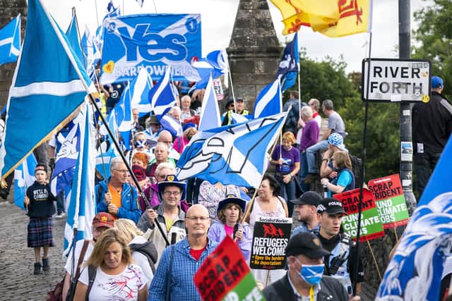 Supporters of Scottish independence march over the Auld Brig on their way to the site of the Battle of Bannockburn for an 'All Under One Banner' rally in Bannockburn,