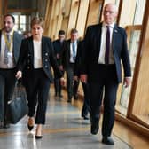 Former first minister Nicola Sturgeon (centre) alongside her former deputy John Swinney. Picture: Andrew Milligan/PA Wire