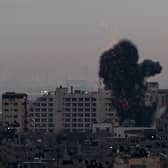 Smoke rises above buildings in Gaza City after Israel launched air strikes on the Palestinian enclave on February 23 (Picture: Mohammed Abed/AFP via Getty Images)