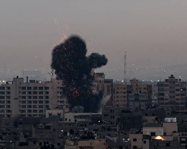 Smoke rises above buildings in Gaza City after Israel launched air strikes on the Palestinian enclave on February 23 (Picture: Mohammed Abed/AFP via Getty Images)