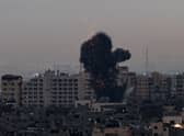 Smoke rises above buildings in Gaza City after Israel launched air strikes on the Palestinian enclave on February 23 (Picture: Mohammed Abed/AFP via Getty Images)