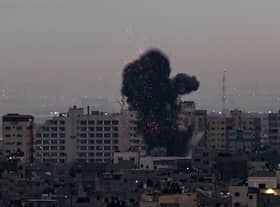 Smoke rises above buildings in Gaza City after Israel launched air strikes on the Palestinian enclave on February 23 (Picture: Mohammed Abed/AFP via Getty Images)