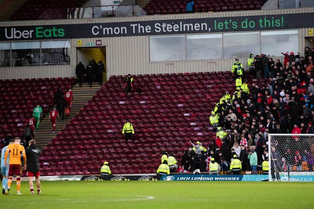 Aberdeen fans vent their frustration as the players leave the pitch after the Scottish Cup defeat at Motherwell. (Photo by Mark Scates / SNS Group)