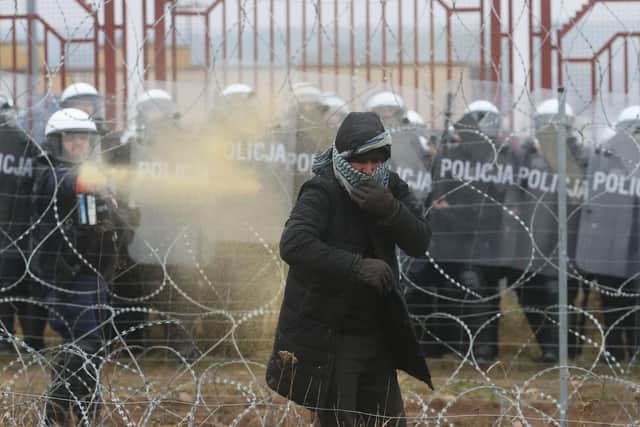 A migrant is pepper-sprayed during clashes with Polish law enforcement officers at the Bruzgi-Kuznica border crossing (Picture: Leonid Shcheglov/Belta/AFP via Getty Images)
