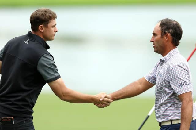 Ludvig Aberg shakes hands with Edoardo Molinari, one of Luke Donald's Ryder Cup vice captains, after they played tohether in the opening two rounds of the Hero Dubai Desert Classic at Emirates Golf Club in January. Picture: Luke Walker/Getty Images.