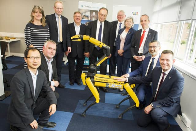 Mr Bailey (centre) whose visit included on-site robot demonstrations from the 5G testbed at Crichton Central. Picture: Jenny Woolgar Photography.