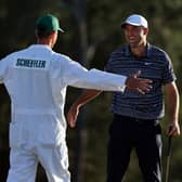 Scottie Scheffler and caddie Ted Scott celebrate on the 18th green after winning the Masters at Augusta National Golf Club. Picture: Gregory Shamus/Getty Images.