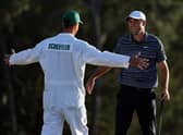 Scottie Scheffler and caddie Ted Scott celebrate on the 18th green after winning the Masters at Augusta National Golf Club. Picture: Gregory Shamus/Getty Images.
