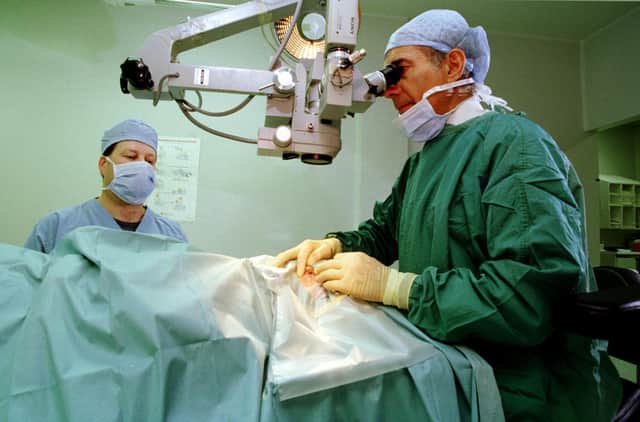 Dr Hector Chawla, clinical director of the Edinburgh Eye Pavilion, with a patient (Picture: Colin Mearns)