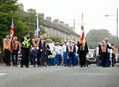 A silent Orange Order band marches through the streets of Easterhouse in Glasgow on Saturday. Picture: PA