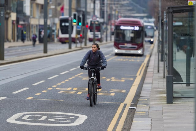 A cyclist on Princes Street, Edinburgh, amid the ongoing coronavirus pandemic. (Photo by Mark Scates / SNS Group)