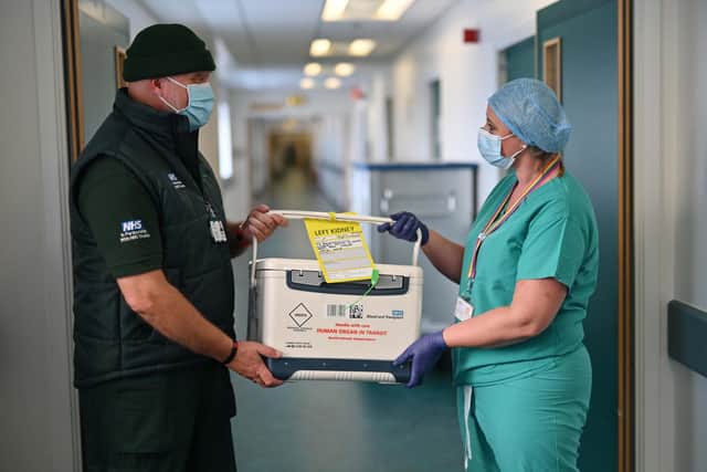 A courier is held the box containing Cat's kidney which he will transport to Edinburgh Airport. The box is passed by, Nina Kunkel, Live Donor Transplant Coordinator. Picture: John Devlin/JPIMedia