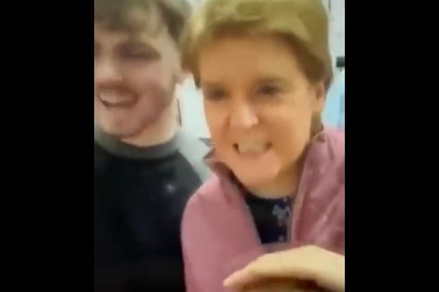 The video shows Nicola Sturgeon not wearing a face mask in a public setting.