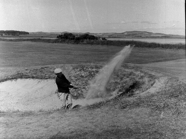 Argentinian golfer Eleido Nari plays from bunker at the 18th hole at St Andrews during the Open Championship in 1964.