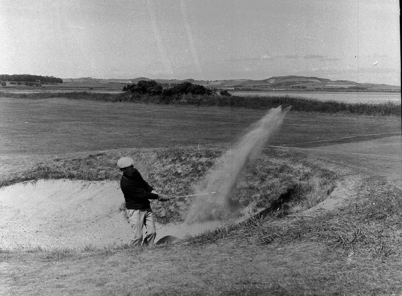 Argentinian golfer Eleido Nari plays from bunker at the 18th hole at St Andrews during the Open Championship in 1964.