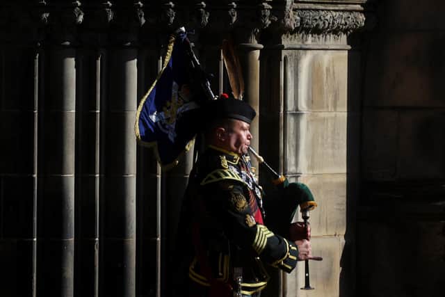 A piper plays as the coffin of Queen Elizabeth II departs St Giles' Cathedral, Edinburgh, after a prayer service. The hearse carrying the coffin of Queen Elizabeth II will depart St Giles' Cathedral, for Edinburgh Airport, where it will be flown by the Royal Air Force to RAF Northolt, then travel onward to Buckingham Palace, London, where it will lie at rest.