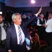 Reform UK leader Nigel Farage waves to supporters 