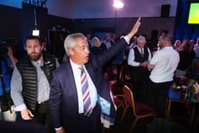 Reform UK leader Nigel Farage waves to supporters 