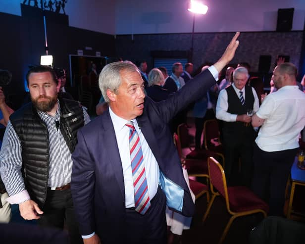 Reform UK leader Nigel Farage waves to supporters 