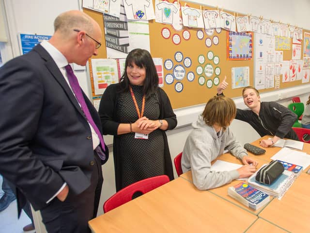 Education Secretary John Swinney speaks with pupils and their teacher in the time before coronavirus (Picture: Ian Rutherford)