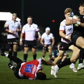 Glasgow Warriors' Tom Jordan bursts through the Lions defence to score his try.