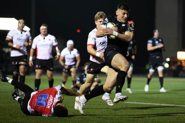 Glasgow Warriors' Tom Jordan bursts through the Lions defence to score his try.