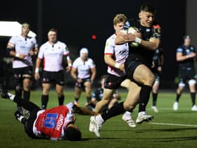 Glasgow Warriors' Tom Jordan bursts through the Lions defence to score his try.