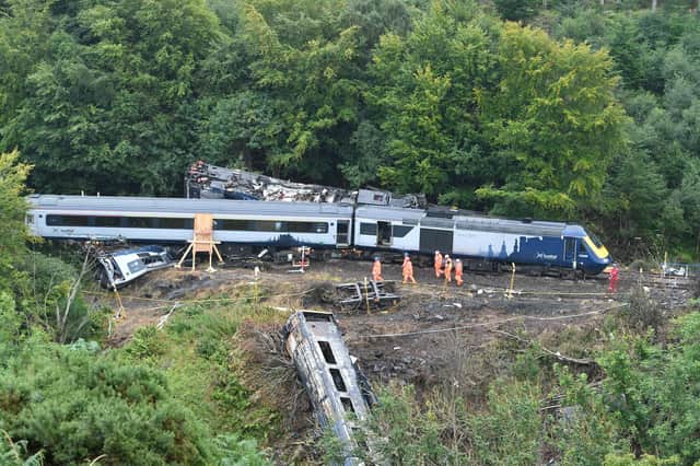 Investigators at the scene of the derailment. Picture: John Devlin