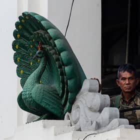 A soldier stands guard in City Hall in Yangon on Monday, after Myanmar's military seized power in a bloodless coup, detaining democratically elected leader Aung San Suu Kyi and imposing a one-year state of emergency. (Picture: STR/AFP via Getty Images)