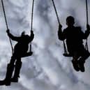 Children playing on swings. PIC: Gareth Fuller/PA Wire