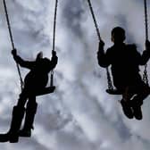 Children playing on swings. PIC: Gareth Fuller/PA Wire