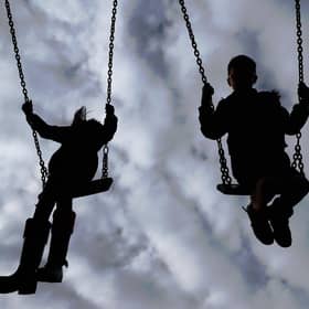 Children playing on swings. PIC: Gareth Fuller/PA Wire