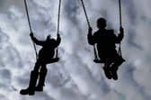 Children playing on swings. PIC: Gareth Fuller/PA Wire