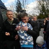 Inessa meets her son Vitaly after the bus delivering him and more than a dozen other children back from Russian-held territory arrived in Kyiv in March.