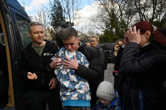 Inessa meets her son Vitaly after the bus delivering him and more than a dozen other children back from Russian-held territory arrived in Kyiv in March.