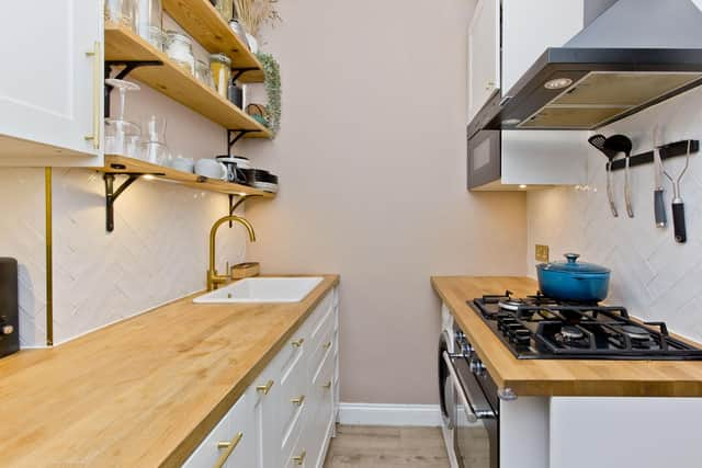 Heringbone tiles and Shaker-style cabinets give the renovated kitchen flair as well as functionality. Image: Krzysztof Wrzos