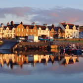 A view of the rocky shore of a small town Port Ellen at sunrise